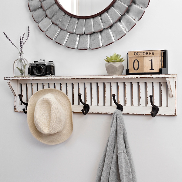 white shelf with hooks below