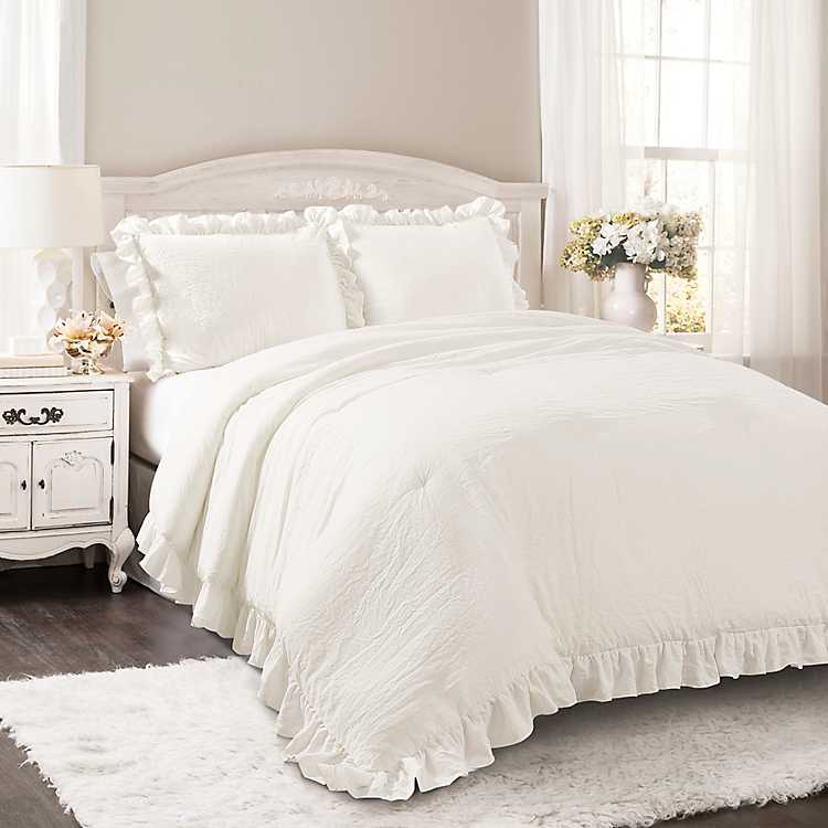 white comforter full with pom poms