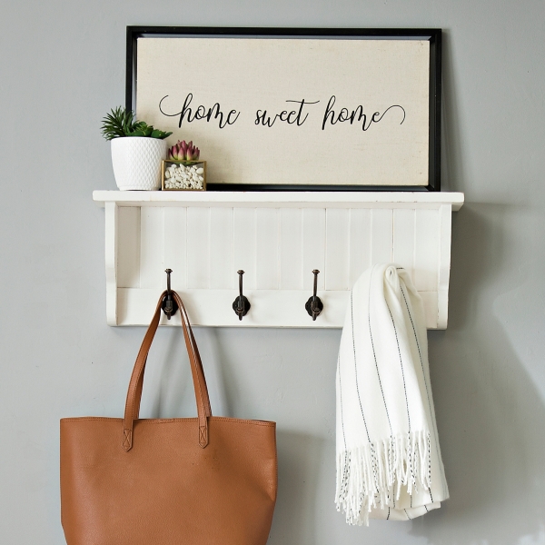 white shelf with hooks for bathroom