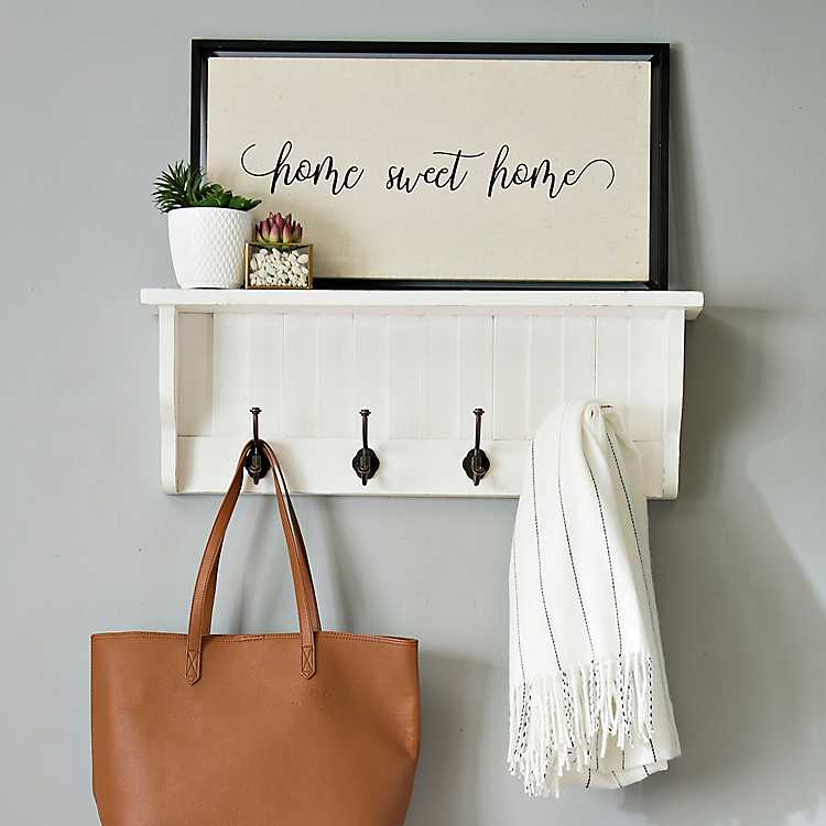 white shelf with hooks and cubbies